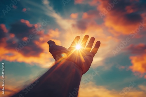 Inspirational Image of a Hand Against a Glowing Sky Full of White Clouds


