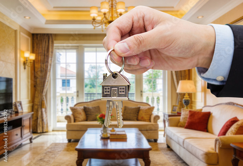 Close-up of hands holding house keys indoors