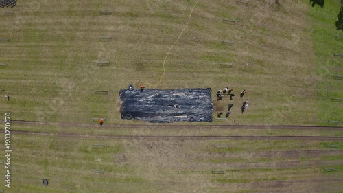 Aerial View of People Sliding on Giant Slip and Slide in Open Field