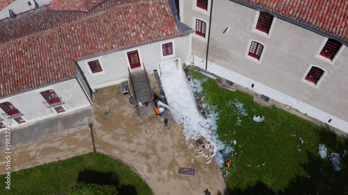 Aerial View of Foam Spill Cleaning Near Historic Building Entrance
