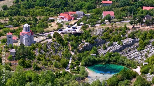 Aerial view of the Cetina River spring, known as the Eye of the Earth, and the nearby Orthodox church in the Dalmatian hinterland, Croatia