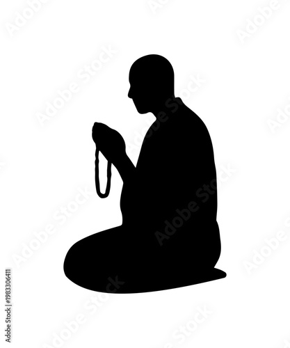 Monk silhouette sits on the floor, hands clasped, and holds a string of beads.