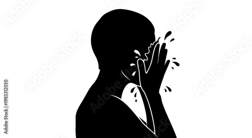 Silhouette of a person splashing water on their face in a refreshing cleansing ritual.