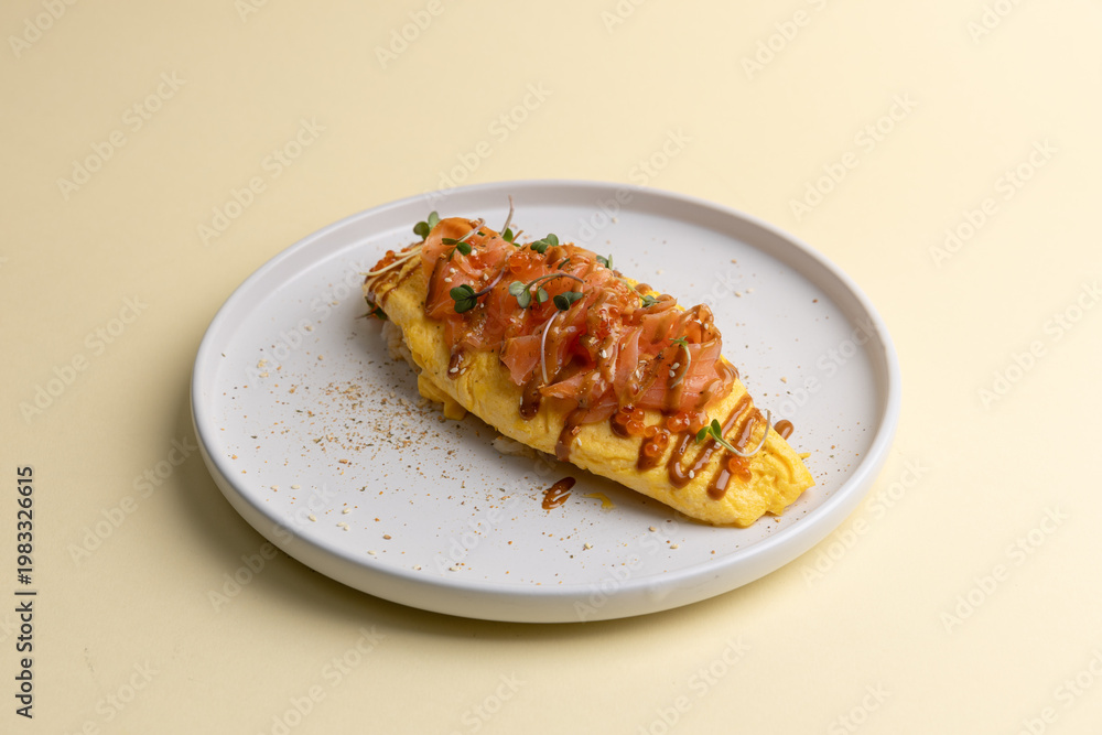 Fototapeta premium Delicious omelet topped with salmon and sauce served on a white plate on a light background
