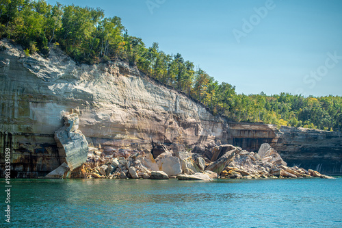 Collapsed sandstone cliff at Pictured Rocks National Lakeshore with large rock debris in Lake Superior following a natural rockfall near Munising, Michigan.