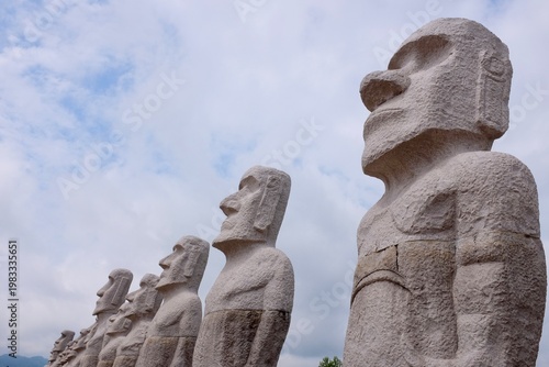 Принти на полотні SAPPORO, JAPAN – JULY 27, 2025: A line of monolithic Moai statue replicas standing tall at the Makomanai Takino Cemetery in Hokkaido, a popular architectural and cultural landmark