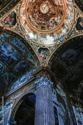 Ornate baroque ceiling fresco with biblical scenes and decorative frames inside Basilica della Santissima Annunziata del Vastato in Genoa, Italy