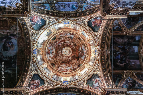 Ornate baroque ceiling fresco with biblical scenes and decorative frames inside Basilica della Santissima Annunziata del Vastato in Genoa, Italy