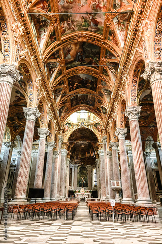 Ornate baroque ceiling fresco with biblical scenes and decorative frames inside Basilica della Santissima Annunziata del Vastato in Genoa, Italy