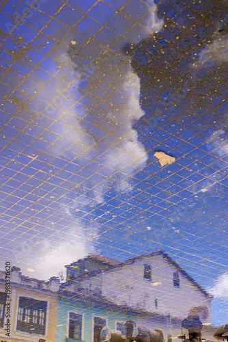 Reflection of Colonial Buildings on Wet Floor