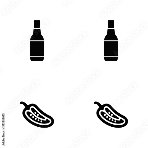 Two Black Beer Bottles and Two Jalapeno Pepper Halves on White Background food drink vegetable spice