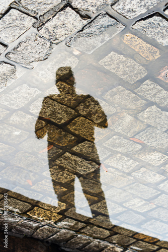 Silhouette of a photographer in a puddle of water