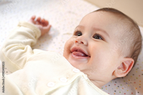 Fotografie Happy newborn baby makes a funny face