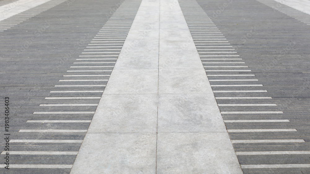 Fototapeta premium Pavement perspective creating a sense of direction and progress, featuring contrasting gray tones and a harmonious blend of abstract patterns with geometric lines