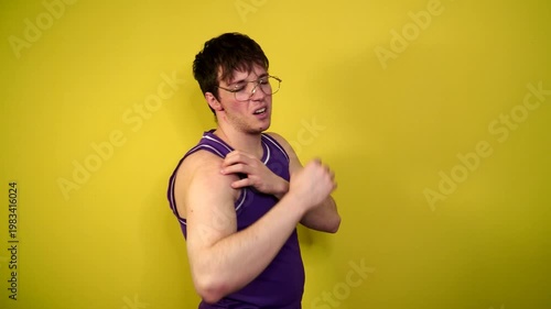 A young attractive guy is involved in sports and fitness. He is stretching.