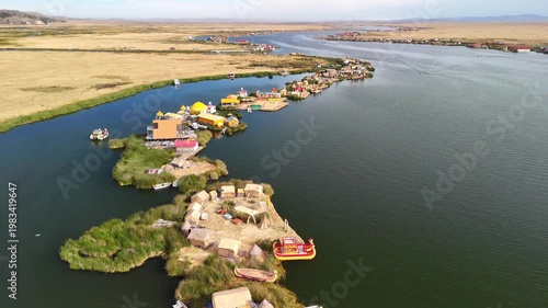 Aerial drone view of the floating Uros Islands on Lake Titicaca. The highest navigable lake in the world, located near Puno, Peru, South America. Popular travel destination.