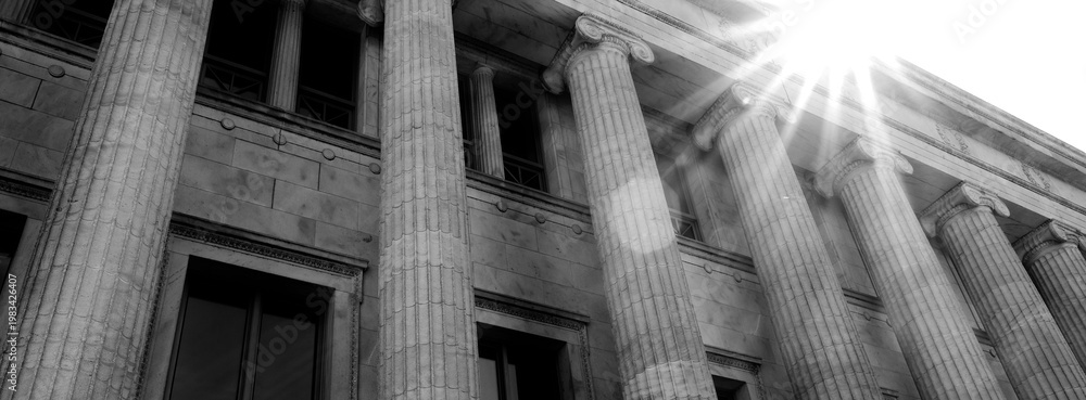 Fototapeta premium Columns on Old Building with Sunstar or Sunshine on Architecture and Design Library Courthouse or Government Building