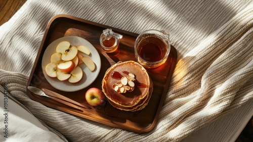 Stack of Pancakes with Syrup and Apple Slices on Wooden Tray