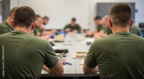 Group of people seated around a table, focused discussion, seen from behind with blurred background