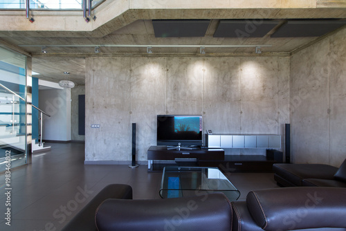 Modern industrial living room interior with concrete walls and minimalist design
