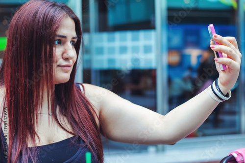 Young Woman Using Smartphone In A Cafe
