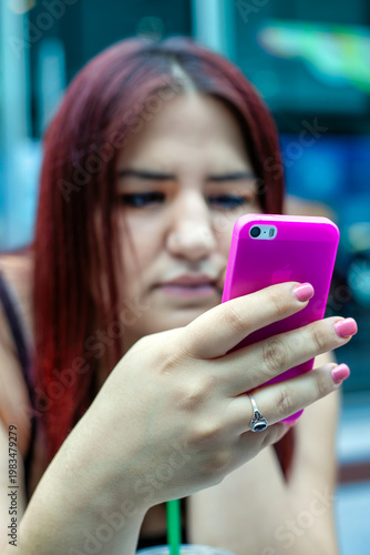 Young Woman Using Smartphone In A Cafe