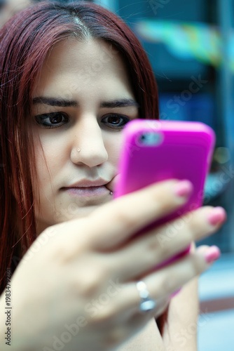 Young Woman Using Smartphone In A Cafe