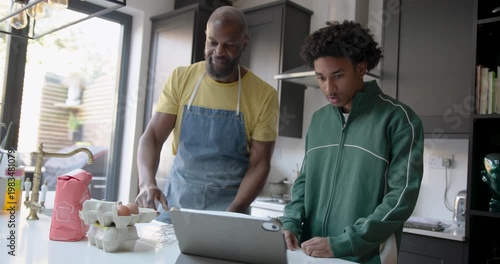Father and son cooking together joyfully