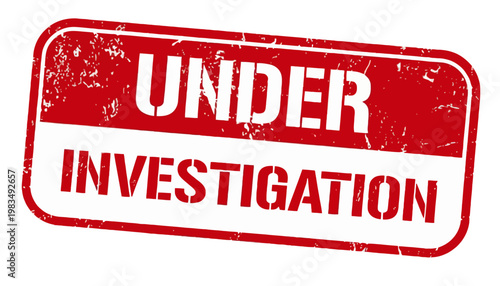A close-up view of a red and white stamp reading Under Investigation on a surface.
