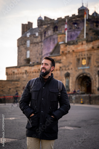 Young Man Looking at the View of Edinburgh Castle during Winter Trip