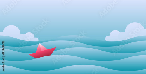 Red paper boat floating on blue wavy water