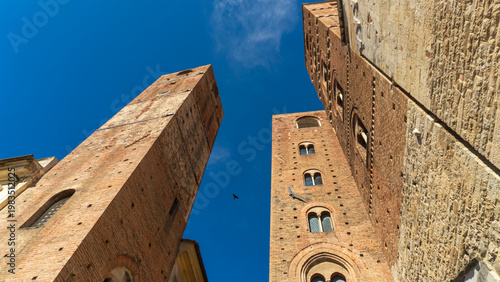 Towers of the old town hall in the medieval historic center with towers and ancient buildings in the Ligurian village of Albenga, province of Savona, Liguria, northern Italy