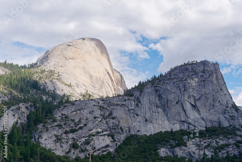 Iconic Half Dome and Liberty Cap granite peaks under a blue sky, Yosemite National Park, California, USA