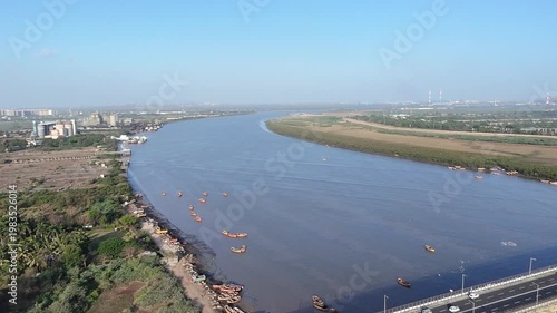 Curved Tapi River aerial landscape with boats and natural shoreline in Surat Gujarat India