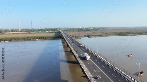 Close aerial view of bridge with vehicles over calm river water in Surat Gujarat India