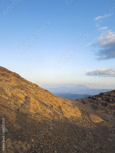 Sunset view over rocky landscape with distant mountain