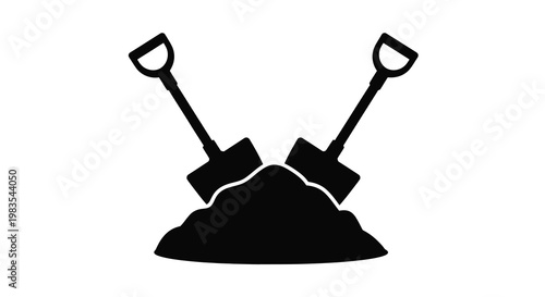 Two black shovels crossed over a pile of dark earth or soil