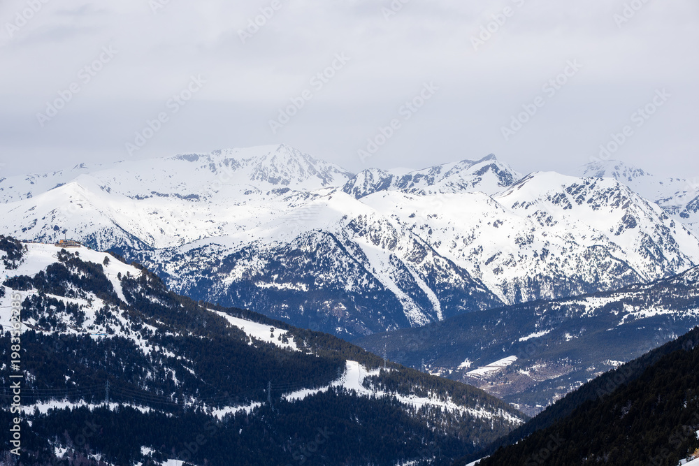 Obraz premium Pas de la Casa ski slopes and snowy Pyrenees mountains