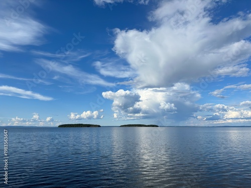 Vast blue lake under a dramatic sky with islands in the distance in Sweden