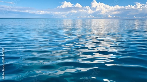 Calm Water Surface Reflects Clouds on Bright Day in Open Space