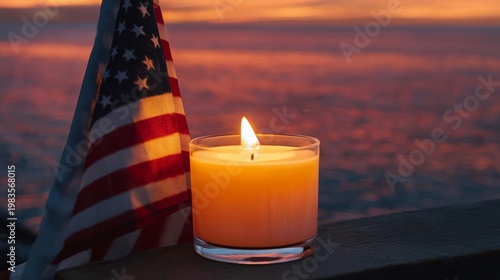 Candle Burns in Front of American Flag With Sunset in the Background at Outdo...