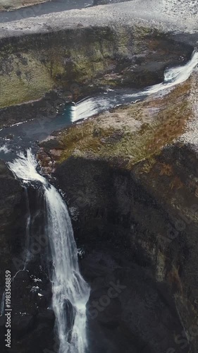 Epic Waterfall in scenic iceland nature, aerial shot - vertical video