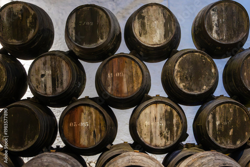 Deep perspective view along stacked barrels in traditional Porto wine cellar, Portugal, Porto, 17.10.2025