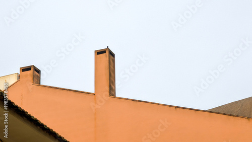 Minimalist rooftop with chimneys against soft morning sky in Porto, Portugal, Porto, 17.10.2025