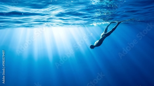 Underwater Swimmer Exploring Blue Waters in Bright Sunlight Near the Ocean Su...