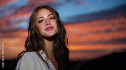 Smiling Woman With Long Hair Stands Against Colorful Sunset Sky