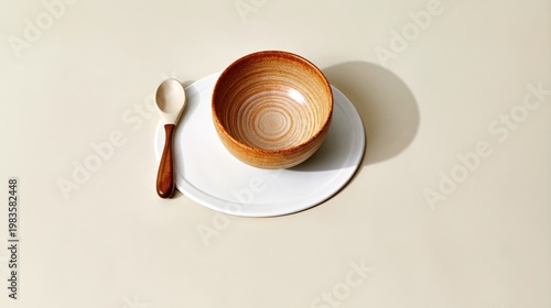 Bowl and Spoon Placed on a White Plate on a Light Surface