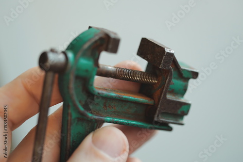 Obraz na plátně A hand grasping a metal vest with a handle, suitable for action or drama scenes