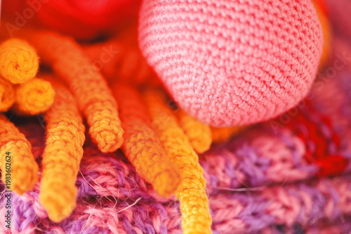 Принти на полотні A colorful pile of crocheted carrots sits atop a stack of yarn, perfect for craf