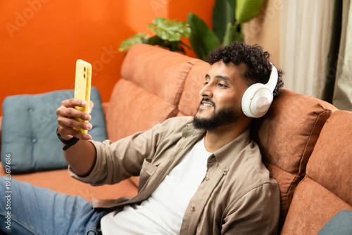 Happy man enjoying music at home